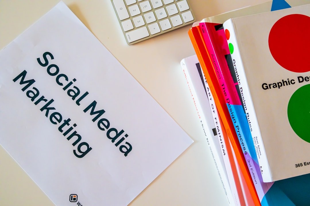 services-01 Home desk with design books and a paper with the words Social Media Marketing on it